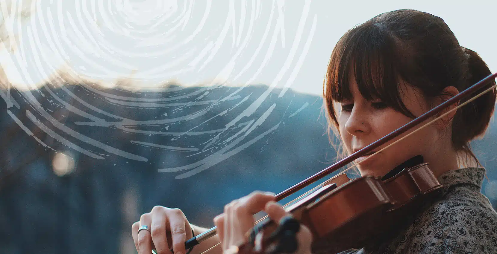 Young woman plays violin outdoors near Siamsa Tíre, the arts centre Tralee Kerry.