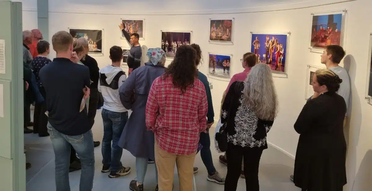 A group views photos on display at a Siamsa Tíre traditional Irish arts performance.
