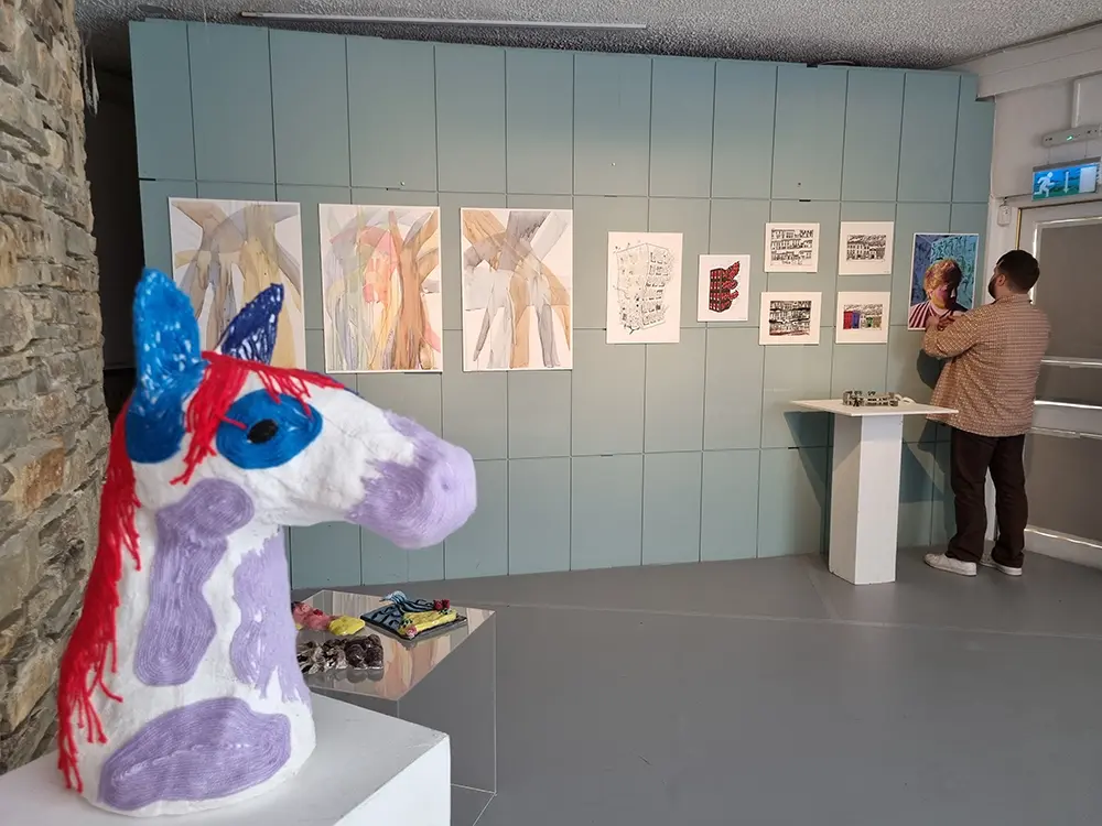 Art gallery with paintings and a striking horse head at Siamsa Tíre theatre Tralee.