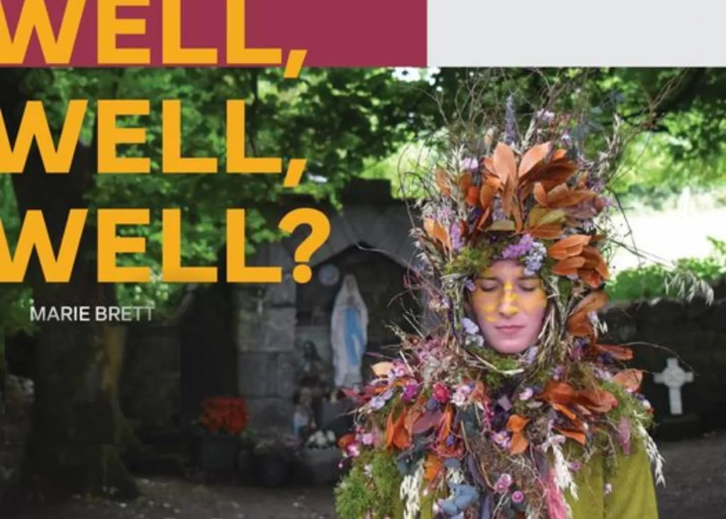 Person in leaf and flower costume at shrine—discover Siamsa Tíre traditional Irish arts performances.