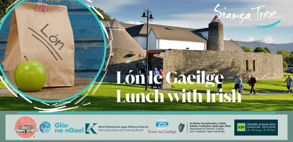 Paper lunch bag, green apple at Arts centre Tralee Kerry, text: Lón le Gaeilge - Lunch with Irish.