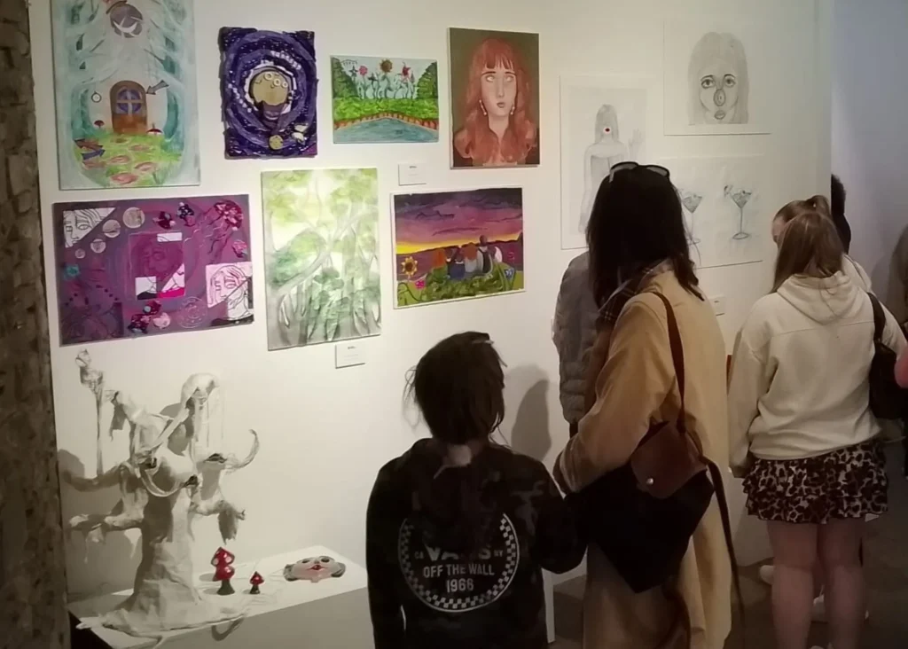 People viewing colorful artwork at Arts Centre Tralee Kerry in Siamsa Tíre theatre.