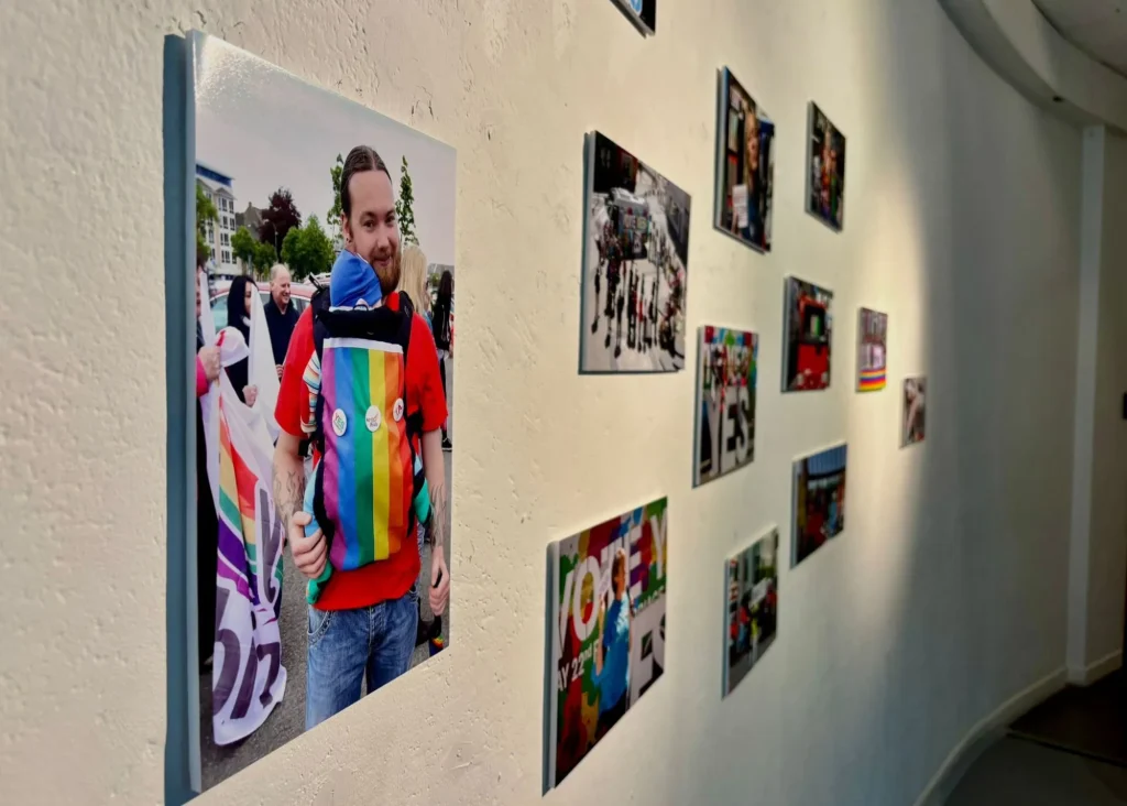 Photos of Pride events at Siamsa Tíre theatre Tralee, with rainbow colors on a curved gallery wall.