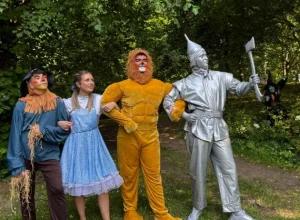 Four people in Wizard of Oz costumes stand together at Siamsa Tíre theatre in Tralee.