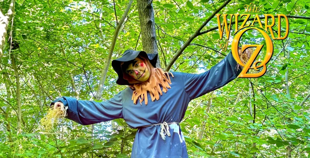 A scarecrow in a forest with "The Wizard of Oz" logo at Arts centre Tralee Kerry.