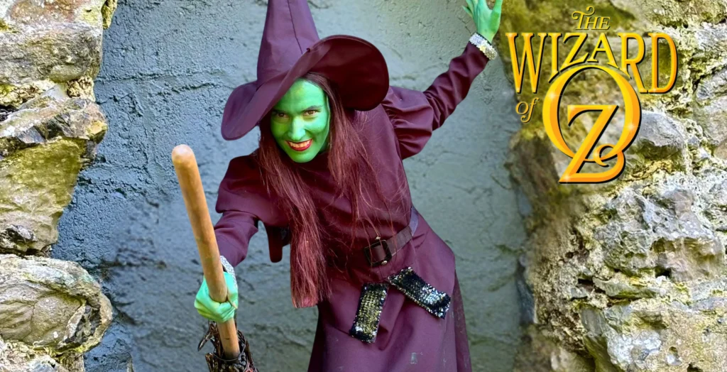 Person in a Wicked Witch costume at Arts Centre Tralee Kerry, smiling and holding a broom.