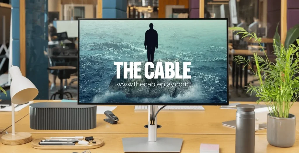 A monitor on a desk shows "THE CABLE" over an image, hinting at Siamsa Tíre theatre Tralee.