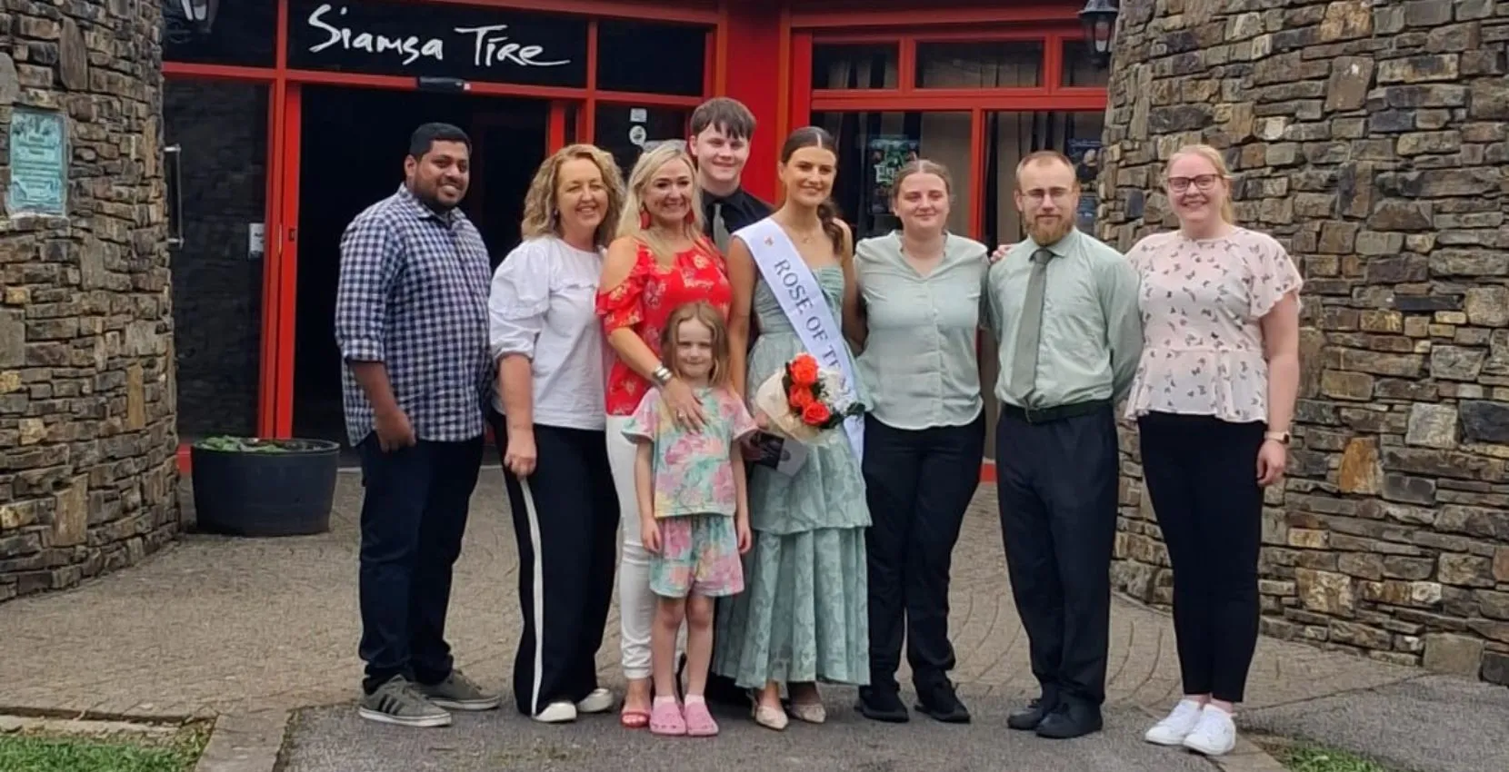 A group pose smiling outside the Arts centre Tralee Kerry, ready for a Siamsa Tíre live show.