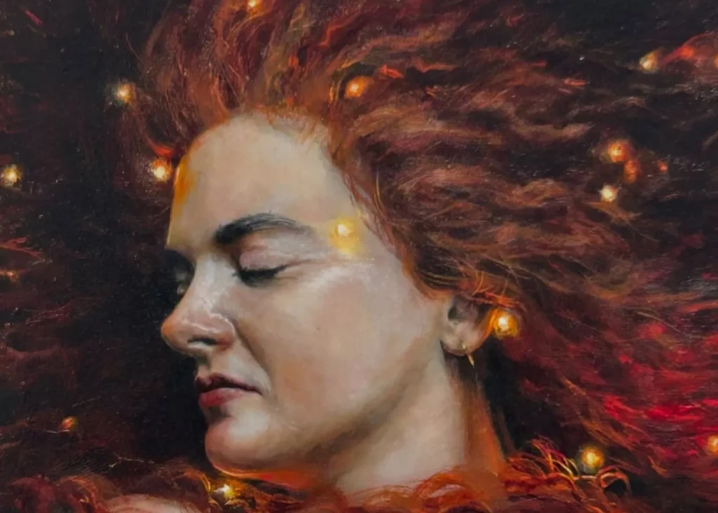 A woman with closed eyes and glowing lights in her hair at Siamsa Tíre theatre Tralee.