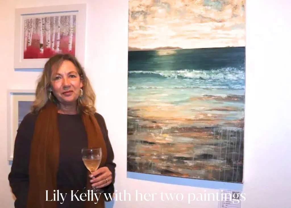 A woman holding a glass of wine stands beside a painting of the ocean