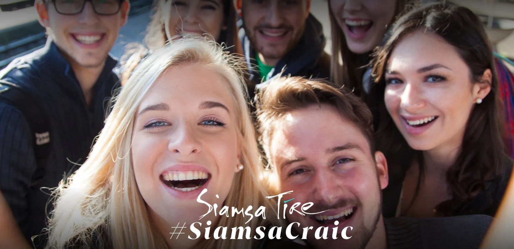 A group of young men and women taking a selfie