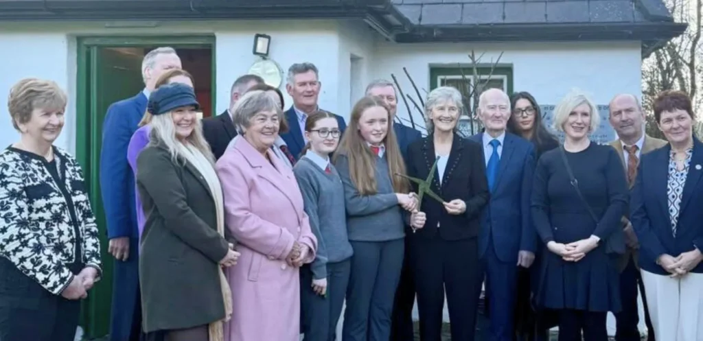 President Connolly standing for a photo with a crowd of people.