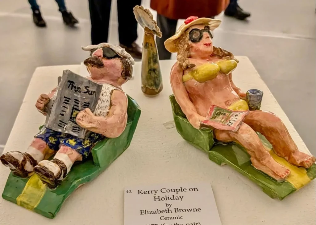 Image of handmade pottery of a middleaged couple lying on a beach in summer wear