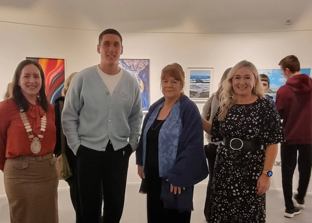 Photo of 4 people standing in an art gallery