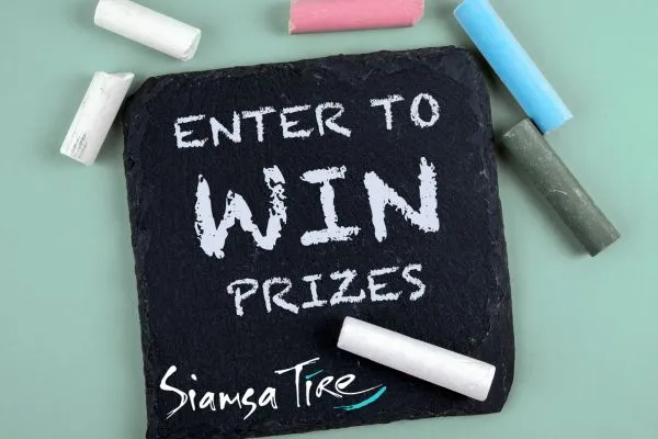 Slate board and chalk with Enter to win prizes written on it