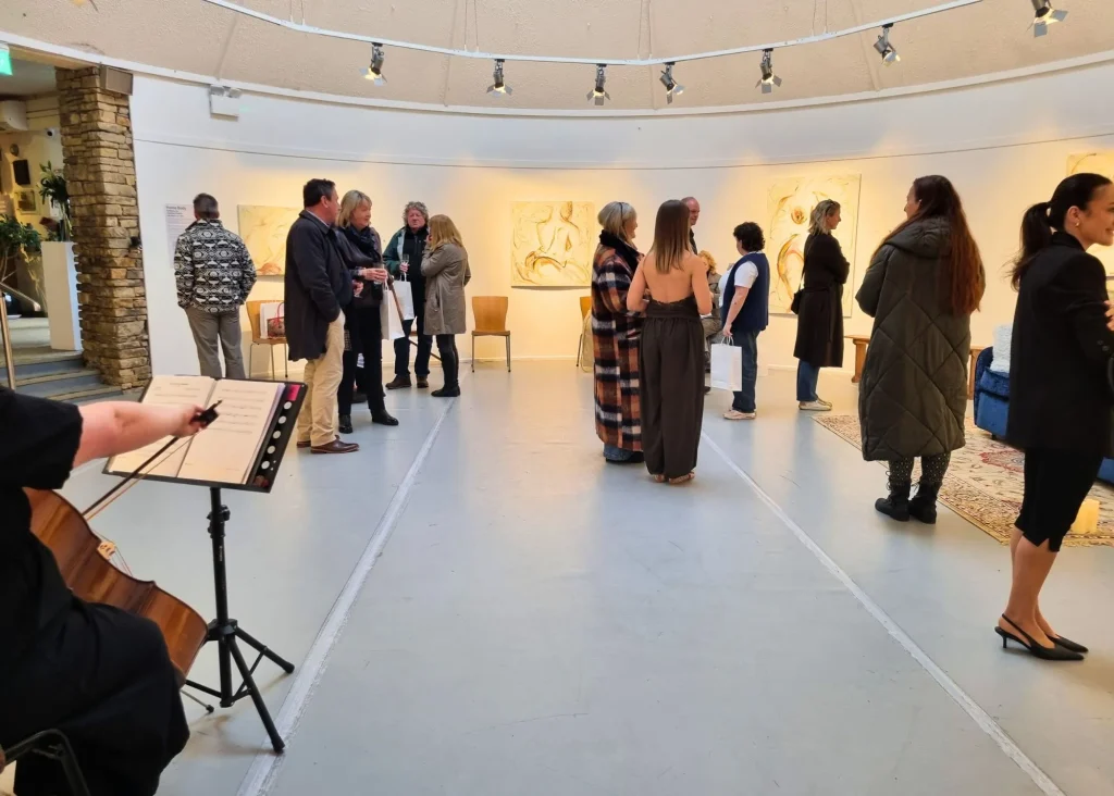 Photo of people looking at art in a gallery