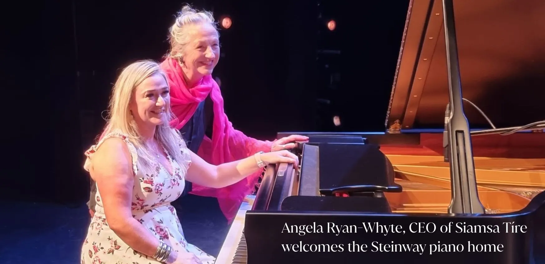 ***Photo of two ladies at a black Steinway Piano