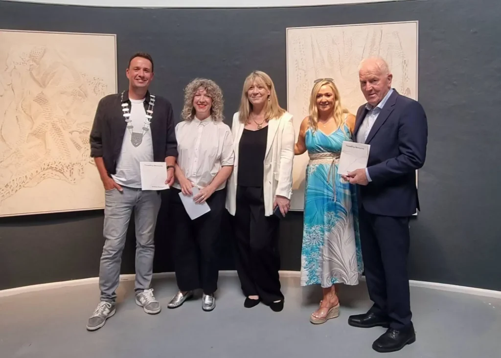 ***Photo of 5 adults standing in an art gallery.
