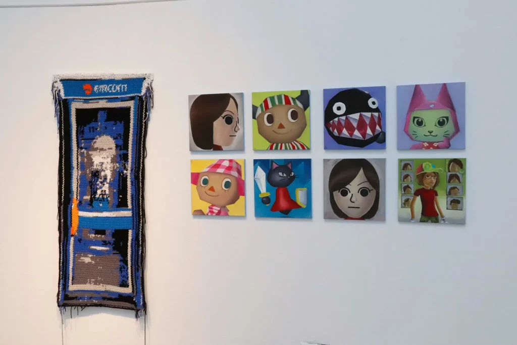 ***Photo of pieces of art hanging on a white wall